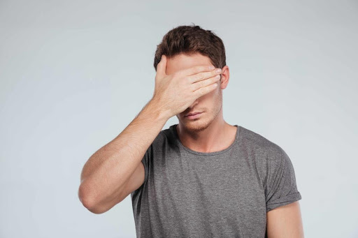 Suffering feelings of shame and guilt? Dr. Dadson can help with clinical counselling Facepalm - Man with grey T-shirt suffering feelings of shame and guilt – Dr. Dadson can help